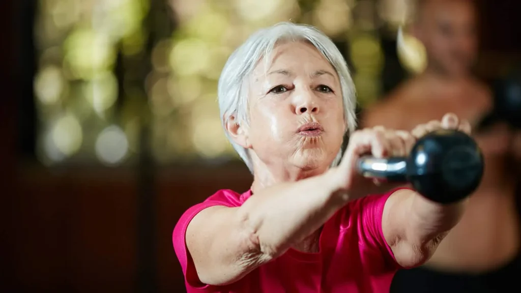 Toning Arms Without the Bulk: Is It Achievable? 1 Woman doing resistance band exercises for toned arms Hertford